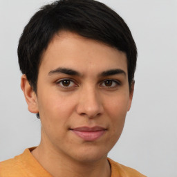 Joyful latino young-adult male with short  brown hair and brown eyes