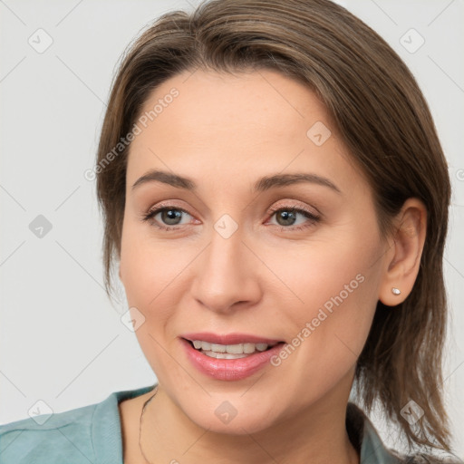 Joyful white young-adult female with medium  brown hair and grey eyes