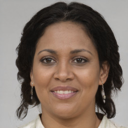 Joyful black adult female with medium  brown hair and brown eyes