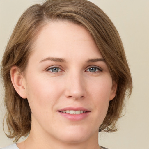 Joyful white young-adult female with medium  brown hair and green eyes