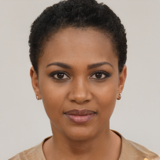 Joyful black young-adult female with short  black hair and brown eyes