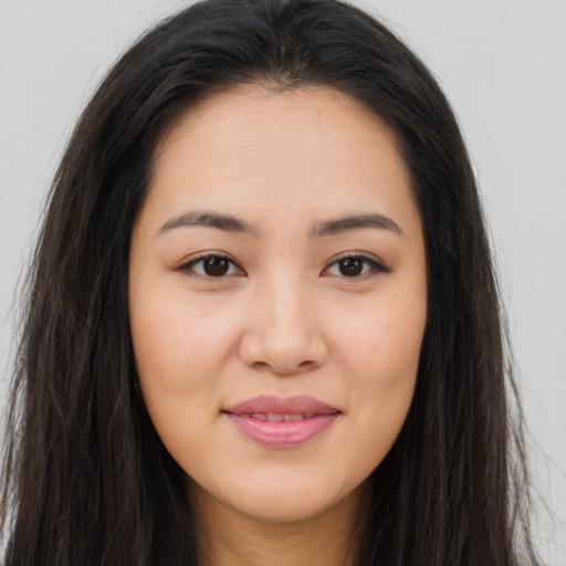 Joyful asian young-adult female with long  brown hair and brown eyes