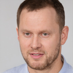 Joyful white adult male with short  brown hair and brown eyes