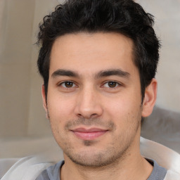 Joyful white young-adult male with short  black hair and brown eyes