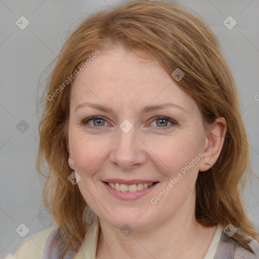 Joyful white adult female with medium  brown hair and blue eyes