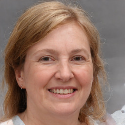 Joyful white adult female with medium  brown hair and grey eyes