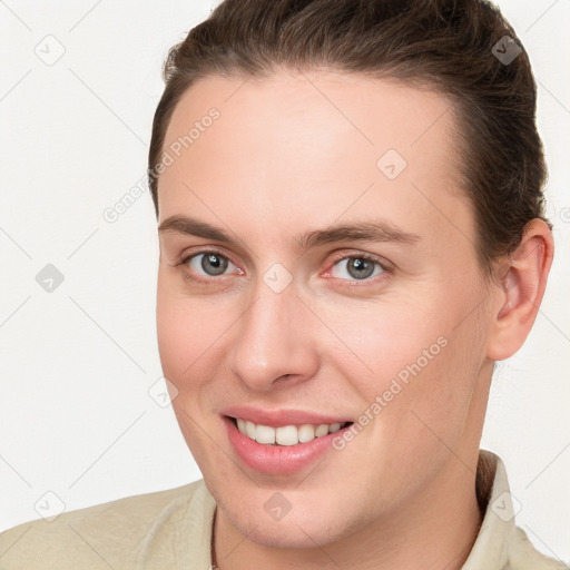 Joyful white young-adult female with short  brown hair and brown eyes