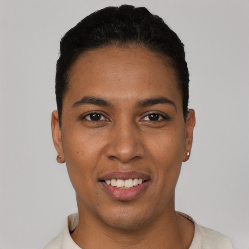 Joyful latino young-adult female with short  black hair and brown eyes