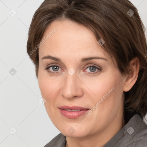 Joyful white adult female with medium  brown hair and grey eyes