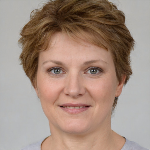 Joyful white adult female with medium  brown hair and blue eyes