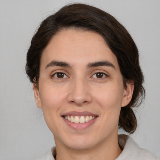 Joyful white young-adult female with medium  brown hair and brown eyes