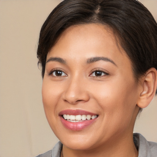 Joyful white young-adult female with medium  brown hair and brown eyes