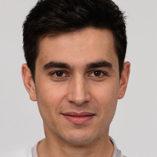 Joyful white young-adult male with short  brown hair and brown eyes