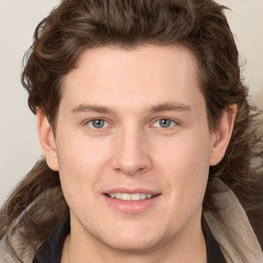 Joyful white young-adult male with medium  brown hair and brown eyes