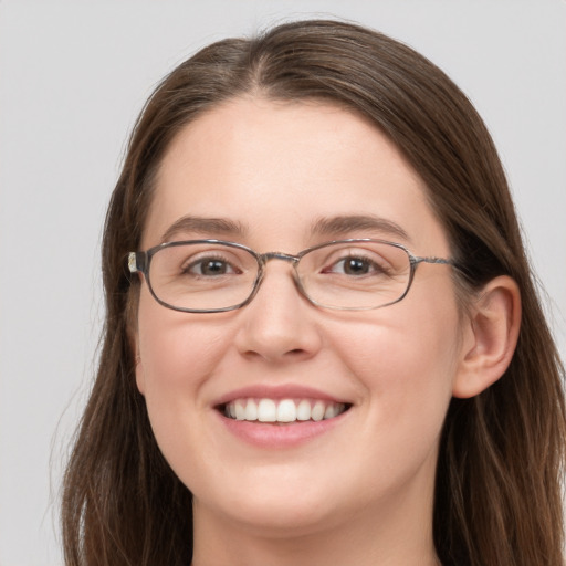 Joyful white young-adult female with long  brown hair and grey eyes