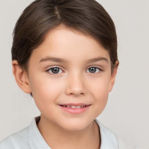 Joyful white child female with short  brown hair and brown eyes