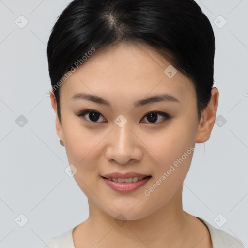 Joyful asian young-adult female with short  brown hair and brown eyes