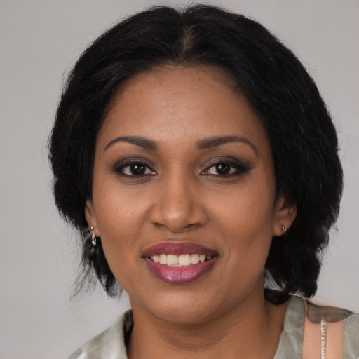 Joyful black young-adult female with medium  black hair and brown eyes