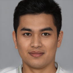 Joyful latino young-adult male with short  brown hair and brown eyes