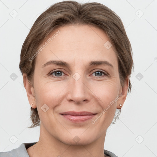 Joyful white adult female with medium  brown hair and grey eyes