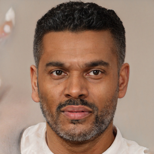 Neutral latino adult male with short  black hair and brown eyes