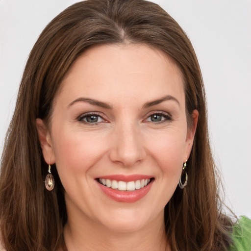 Joyful white young-adult female with long  brown hair and grey eyes