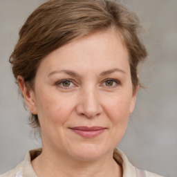 Joyful white adult female with medium  brown hair and grey eyes