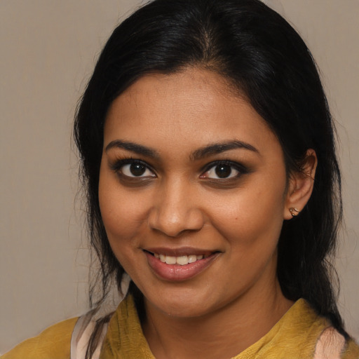 Joyful black young-adult female with medium  brown hair and brown eyes