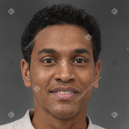 Joyful black young-adult male with short  brown hair and brown eyes