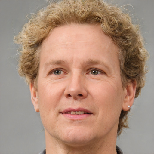 Joyful white adult male with medium  brown hair and grey eyes