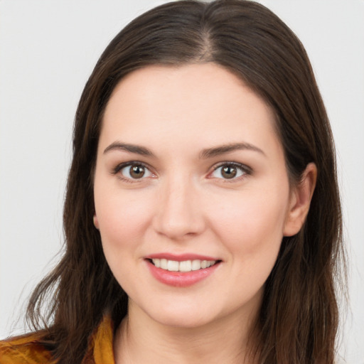 Joyful white young-adult female with long  brown hair and brown eyes