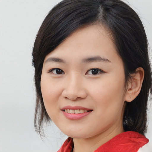 Joyful asian young-adult female with medium  brown hair and brown eyes