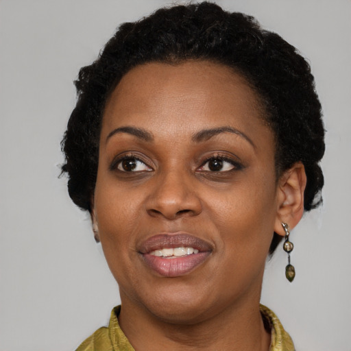 Joyful black adult female with short  brown hair and brown eyes