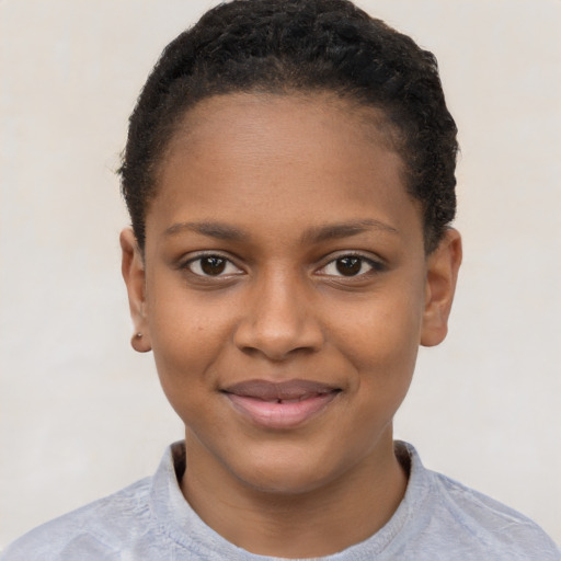 Joyful black child female with short  brown hair and brown eyes