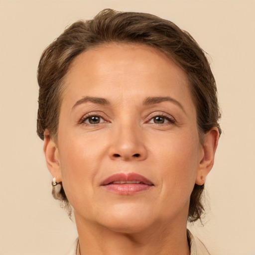 Joyful white adult female with medium  brown hair and brown eyes