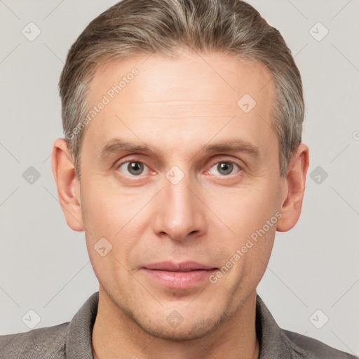 Joyful white adult male with short  brown hair and grey eyes