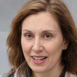 Joyful white adult female with long  brown hair and brown eyes