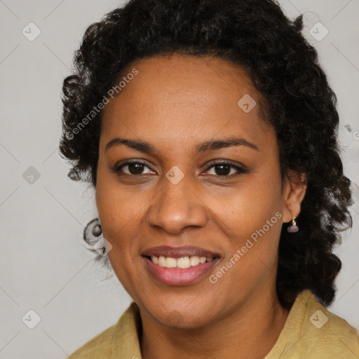 Joyful black young-adult female with long  brown hair and brown eyes