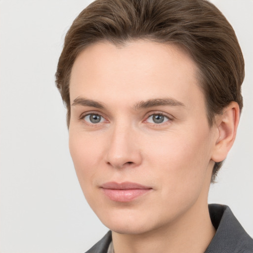 Joyful white young-adult female with short  brown hair and grey eyes