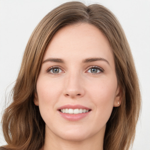 Joyful white young-adult female with long  brown hair and green eyes