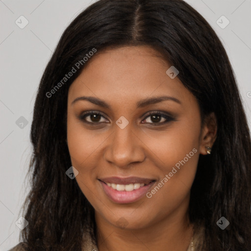 Joyful black young-adult female with long  brown hair and brown eyes