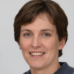 Joyful white adult female with medium  brown hair and grey eyes