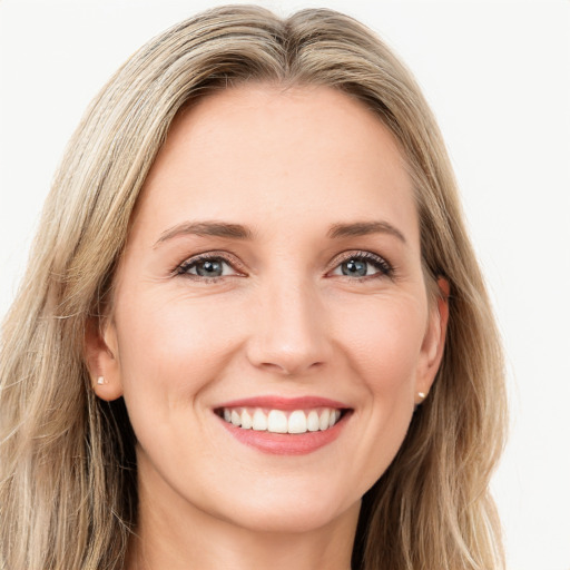 Joyful white young-adult female with long  brown hair and green eyes