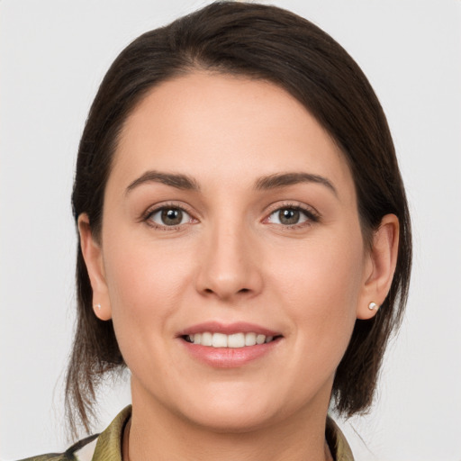 Joyful white young-adult female with medium  brown hair and brown eyes