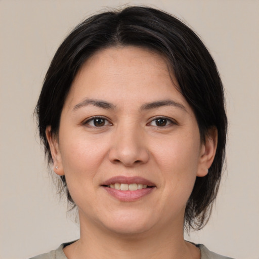 Joyful asian young-adult female with medium  brown hair and brown eyes
