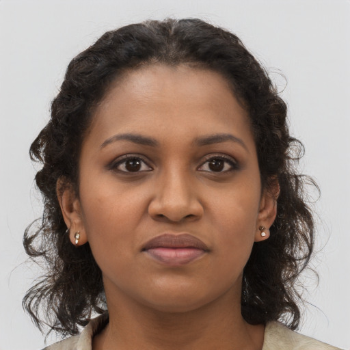 Joyful black young-adult female with medium  brown hair and brown eyes