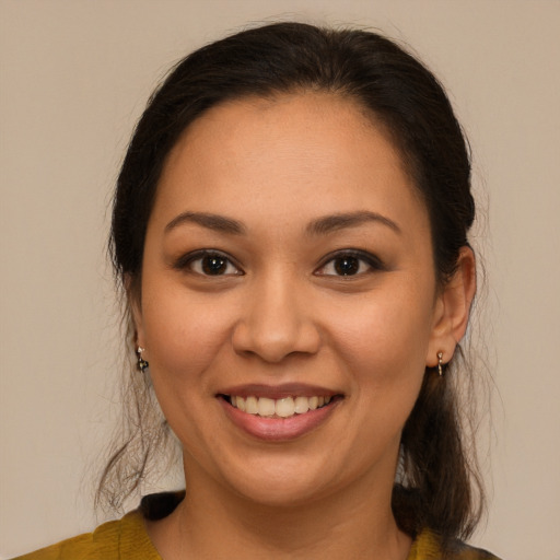 Joyful latino young-adult female with medium  brown hair and brown eyes