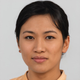 Joyful asian young-adult female with short  brown hair and brown eyes