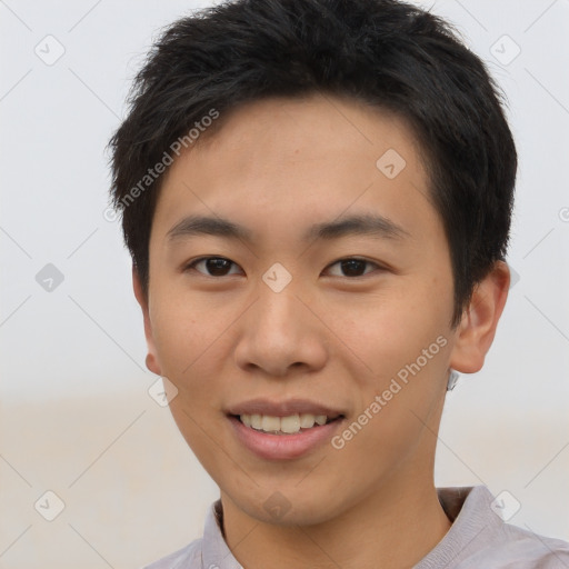 Joyful asian young-adult male with short  brown hair and brown eyes