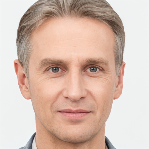 Joyful white adult male with short  brown hair and grey eyes